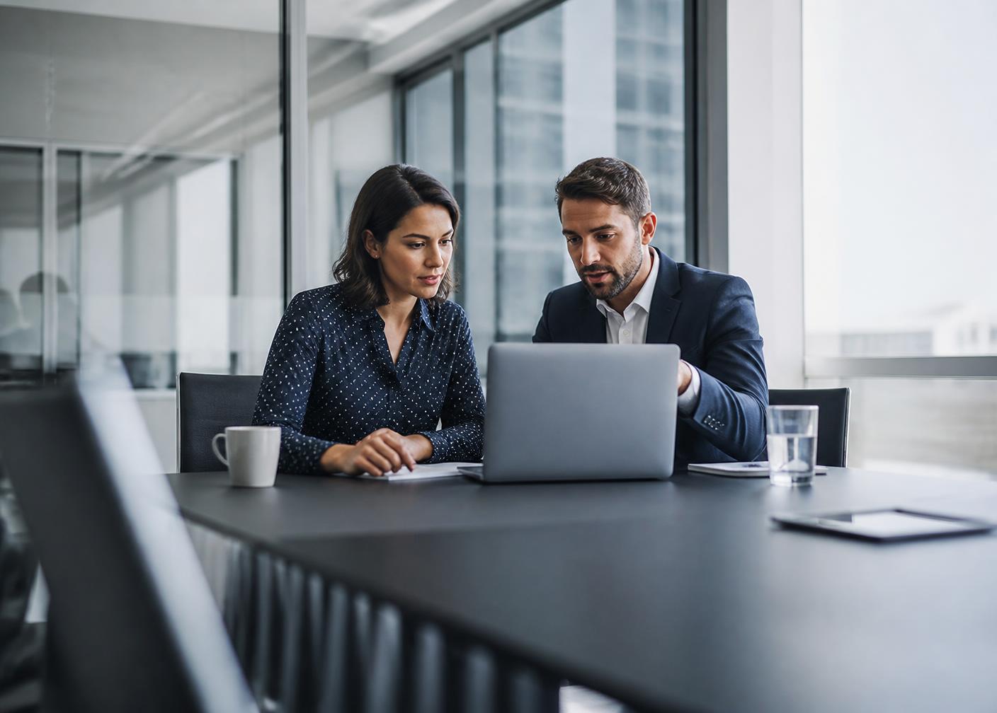 Two professionals reviewing technology options together